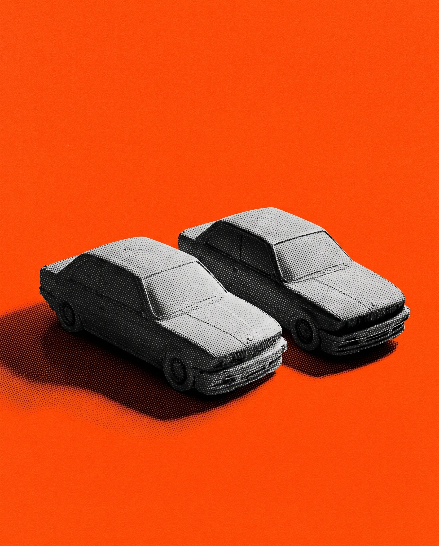 The actual first pair of raw concrete saloons, shot in the studio on a hazard-orange field